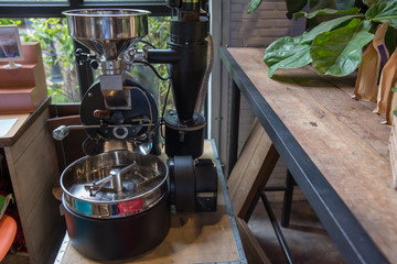 Roasting machine. Spinning cooler professional machine. Industry concept . Freshly roasted machine coffee beans.