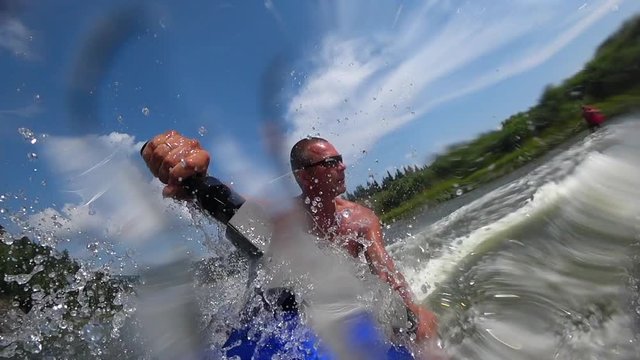 muscular guy on a jet ski. riding a jet ski on a mountain river. beautiful squall of water close-up, splashes of water and turns on jet ski. front view. bright sky. stock videos. super slow motion