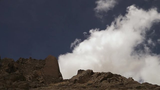 Low angle fast motion still shot of white Cirrus floccus Himalaya clouds being moved by strong winds, from a weathered mountain top. 
