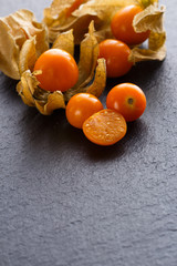 juicy winter cherry on a dark stone background