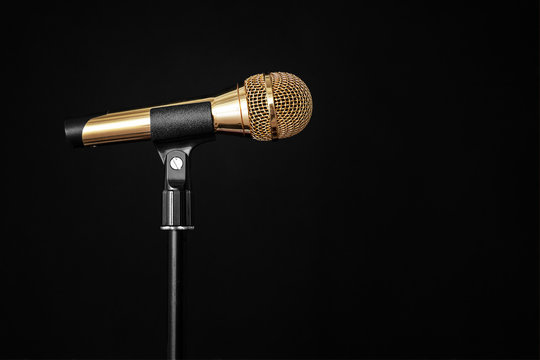 Gold Microphone On Stage On A Black Background