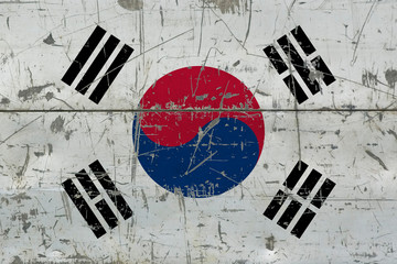 Grunge South Korea flag on old scratched wooden surface. National vintage background.