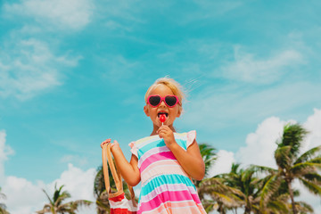happy cute little girl with lollipop on summer vacation