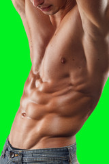 Males model poses in studio with naked torso, showing toned relief torso, isoaletd on chroma key background.