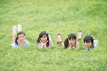 草原に寝転ぶ小学生