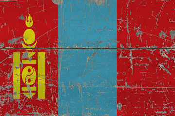 Grunge Mongolia flag on old scratched wooden surface. National vintage background.