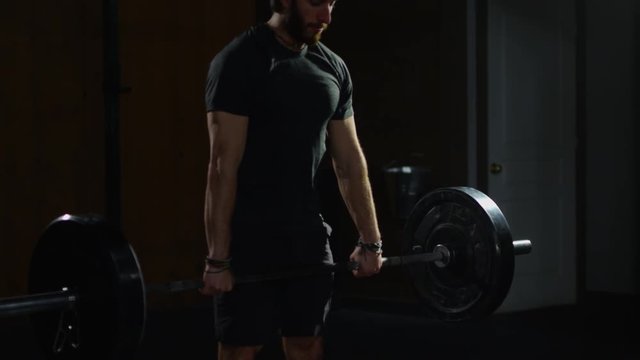 Young guy in crossfit gym working out