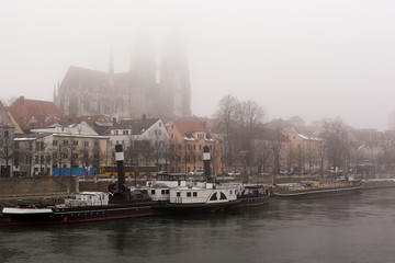 Foggy winter day on Danube promenade in Regensburg