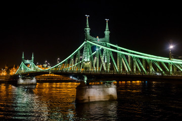 Fototapeta na wymiar Budapest, March 8, 2018, Liberty Bridge over the Danube River, night view of the building from the side of the Gelard Mountain