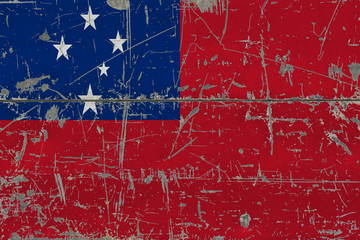Grunge Samoa flag on old scratched wooden surface. National vintage background.