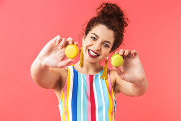 Happy pretty redhead woman wearing in dress showing sweets