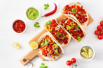 mexican beef and pork tacos with salsa, guacamole and vegetables