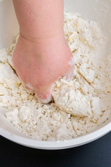 Mixing in a bowl of ingredients butter, cottage cheese and flour for the preparation of cookies