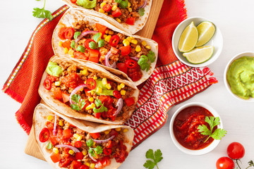 mexican beef and pork tacos with salsa, guacamole and vegetables