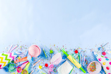 Naklejka premium Sweet baking concept for birthday holiday party, cooking background with baking stuff - rolling pin, whipping whisk, cookie cutters, sugar sprinkling, flour. Light blue background, above copy space
