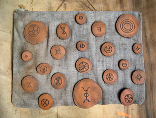 Clay charms round shape with a primitive pattern
