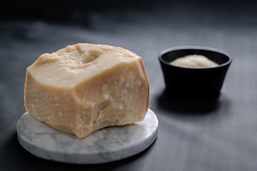 block of parmigiano and black background