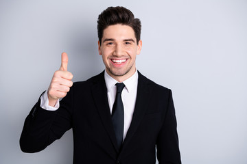 Close up photo amazing toothy he him his macho handsome hand arm thumb up advising buy buyer new tested product wear white shirt black suit jacket tie formal-wear isolated bright grey background