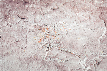 Old grungy cracked white and grey weathered wall paint peeling off rusted metal sheet. Textured background for posters and bloggers