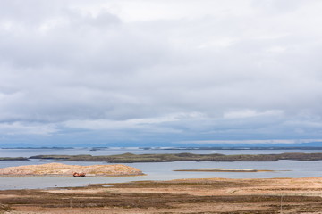 Landscape with an old boat stranded on the background of a beautiful sky and horizon