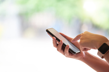 Close up girl pointing finger on screen smart phone on blur background text mobile, mock up glitter street, content lifestyle