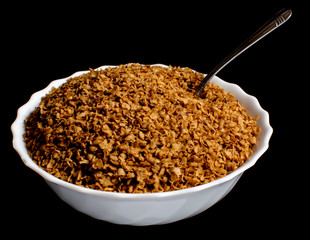 Buckwheat flakes in a white plate with a spoon in them