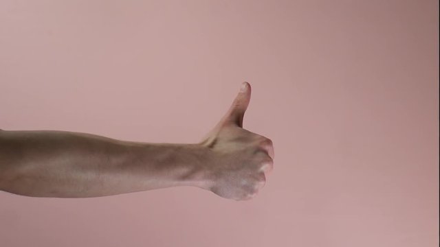 Quick side view hand extension from fist to thumbs up