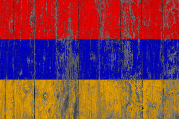 Flag of Armenia painted on worn out wooden texture background.