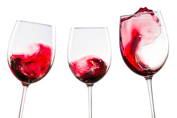 red wine with splashes in glasses on a white background isolated