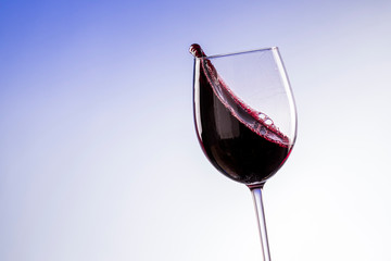 red wine in a glass with a splash