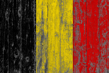Flag of Belgium painted on worn out wooden texture background.