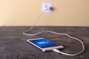 Mobile smart phones,phone charging on rock desk