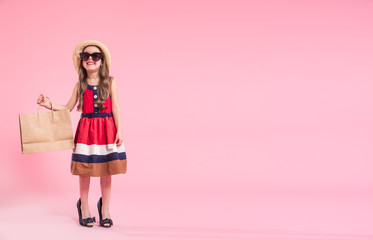 little fashionista on a colored background in mom's shoes