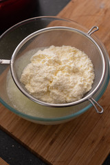 Freshly made ricotta cheese in a sieve