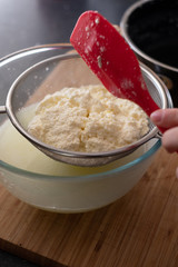 Freshly made ricotta cheese in a sieve