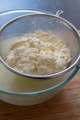 Freshly made ricotta cheese in a sieve