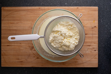 Freshly made ricotta cheese in a sieve