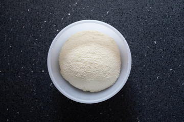 Freshly made ricotta cheese in a container