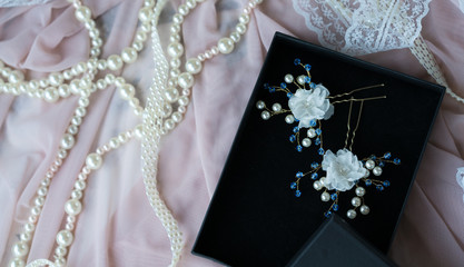 Wedding background with pearls and hair accessories on pink background