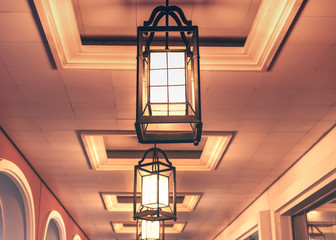Close-up view of lit antique lanternes in the gallery.