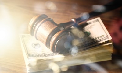 Wooden gavel on wooden table and money , on  background