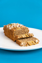 Almond bread loaf with Almond diced and Banana sliced set on Blue Background.