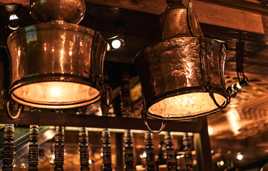 Two beautiful brass vintage lamps in a cafe.