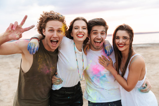 Group of a cheerful young friends having fun at the beach