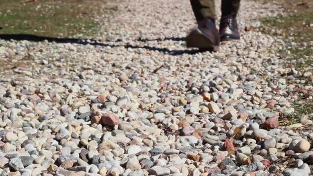 Coming back home, man walking on stone gravel, close up shot