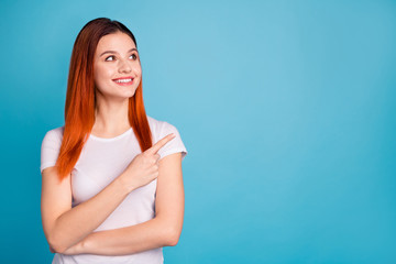 Portrait of her she nice attractive lovely confident cheerful cheery positive girl wearing white t-shirt pointing aside ad copy space recommend isolated over bright vivid shine blue background