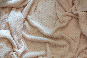 Fototapeta na wymiar Fluffy blanket with wrinkles. Texture background pattern
