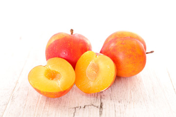 fresh plum on wood background