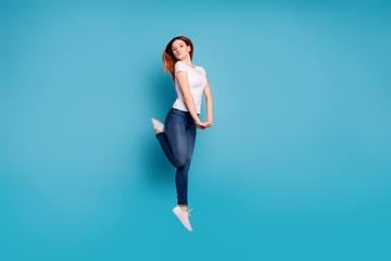 Full length body size profile side view portrait of nice attractive cheerful cheery girlish funny childish girl in white tshirt having fun isolated on bright vivid shine blue background