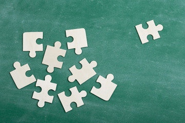 Creative solution for idea - business concept, jigsaw puzzle on the blackboard